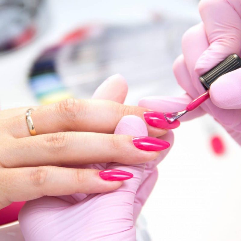Manicurist Apply Nail Polish. Close-up Of A Woman Applying Nail